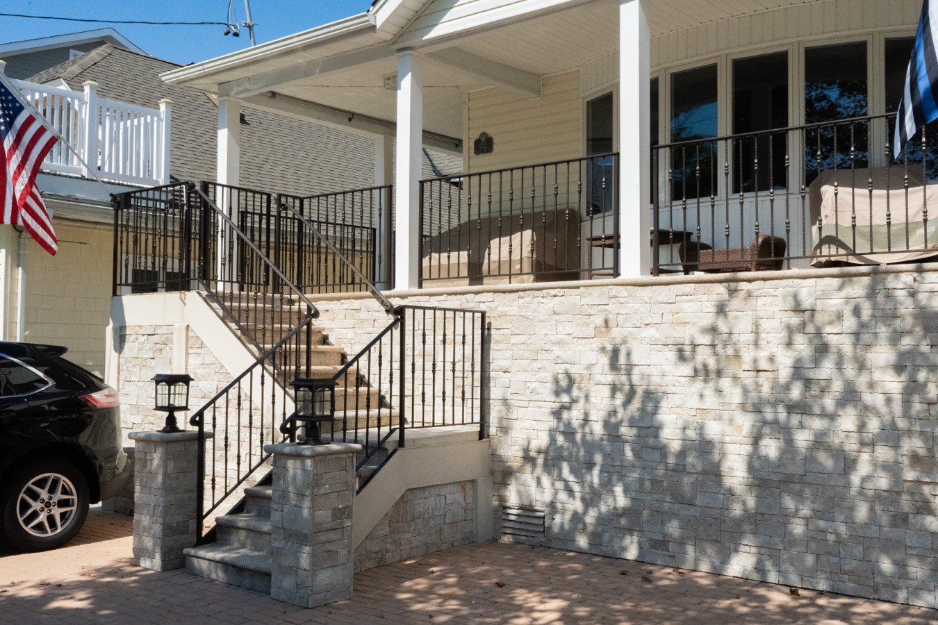 Stone porch and railings on a Queens home rebuilt by SJNY Construction